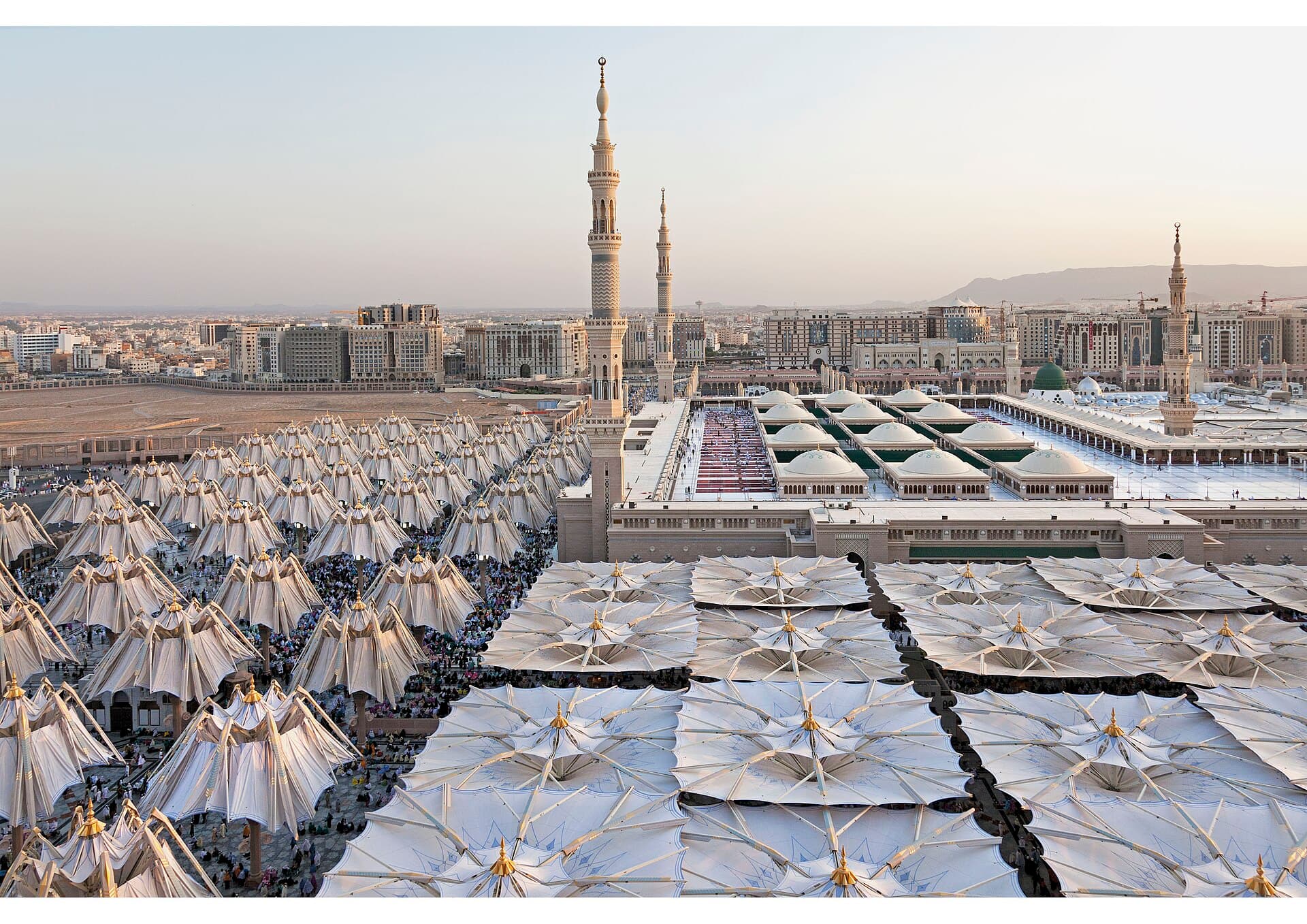 The piazza umbrellas of Masjid an-Nabawi at dusk